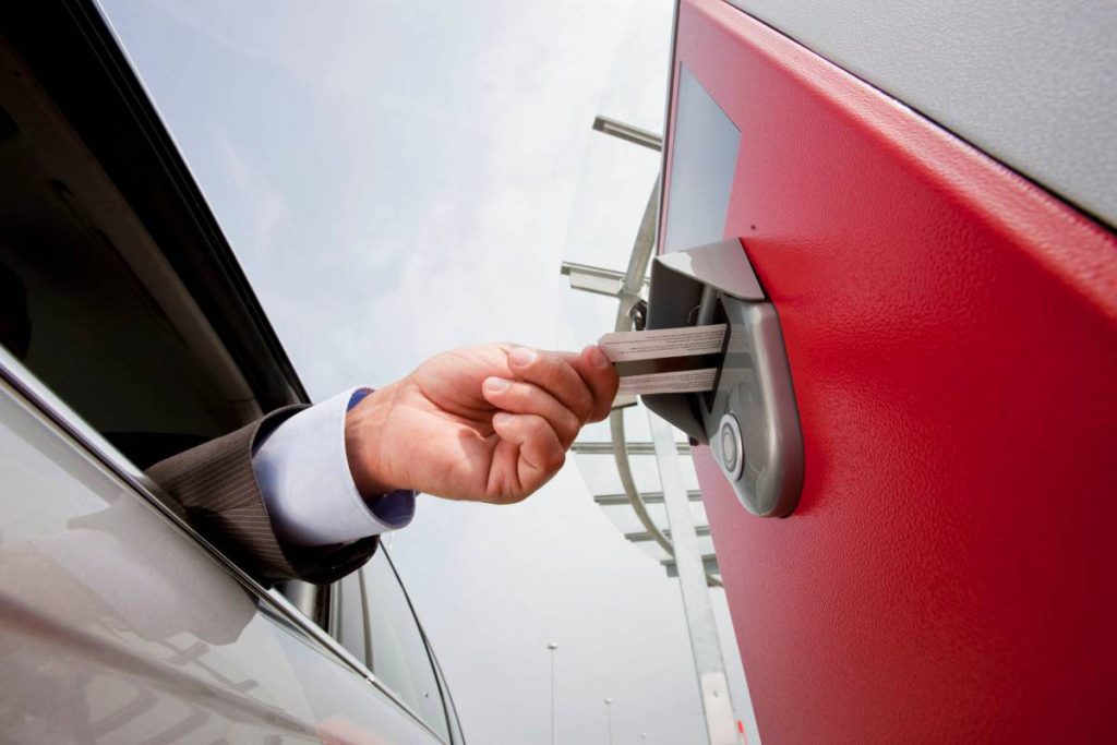 Image of driver Inserting ticket in machine